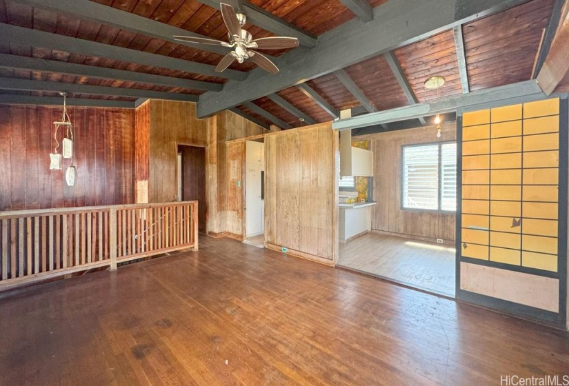 Upstairs Living Room. Open beam ceiling with hardwood flooring.