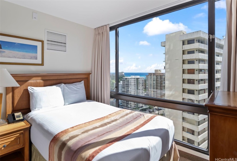 Floor to ceiling windows allow natural light to fill the room while overlooking Waikiki.