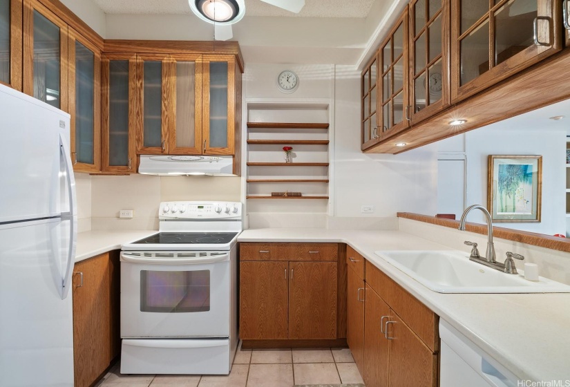This customized kitchen has oodles of storage, including a floor to ceiling storage area to the left of the fridge.