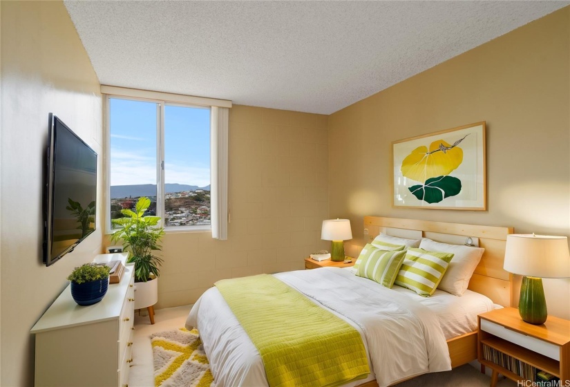 Virtually Staged.  The bedroom can accommodate a king size bed.  The window provides great views and cool breezes.  Window AC units are included with unit and may not cool to displayed temperature setting.