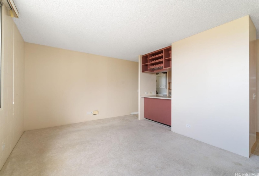 Spacious and bright living room connecting to the kitchen with the dining counter.