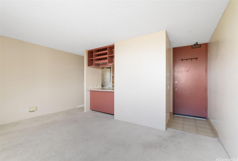 Unit door to the left with kitchen entrances to left of the entrance door and left of the dining counter.