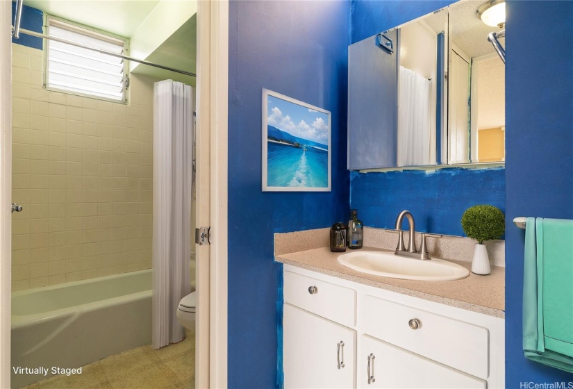 Virtually Staged.  Bathroom area conveniently located right outside the bedroom so guests don'tt have to pass through the bedroom for access.  The sink and vanity are separate from the tub/shower with sliding door between.