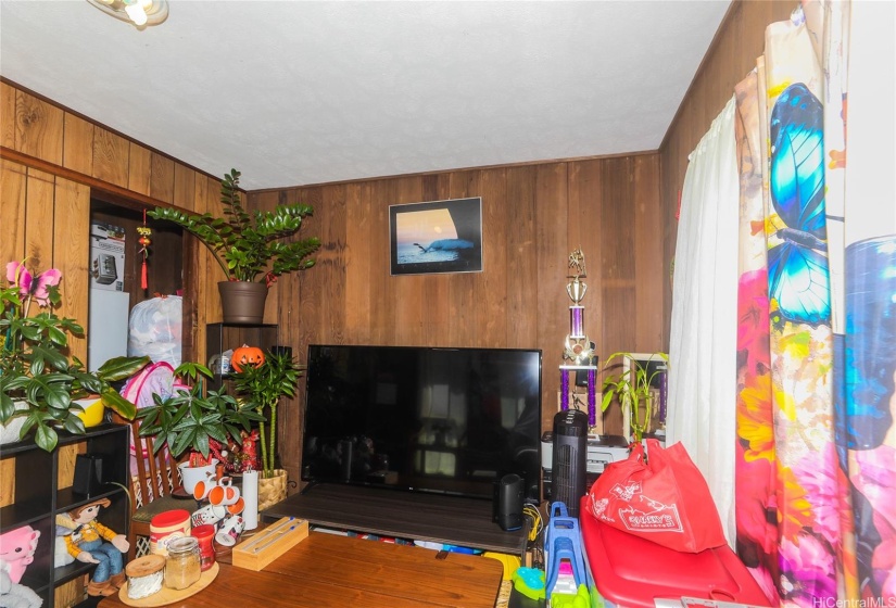 Living room with wood paneling on all walls