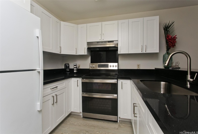 Shiny new kitchen opens to wonderful, cozy living space and private patio!