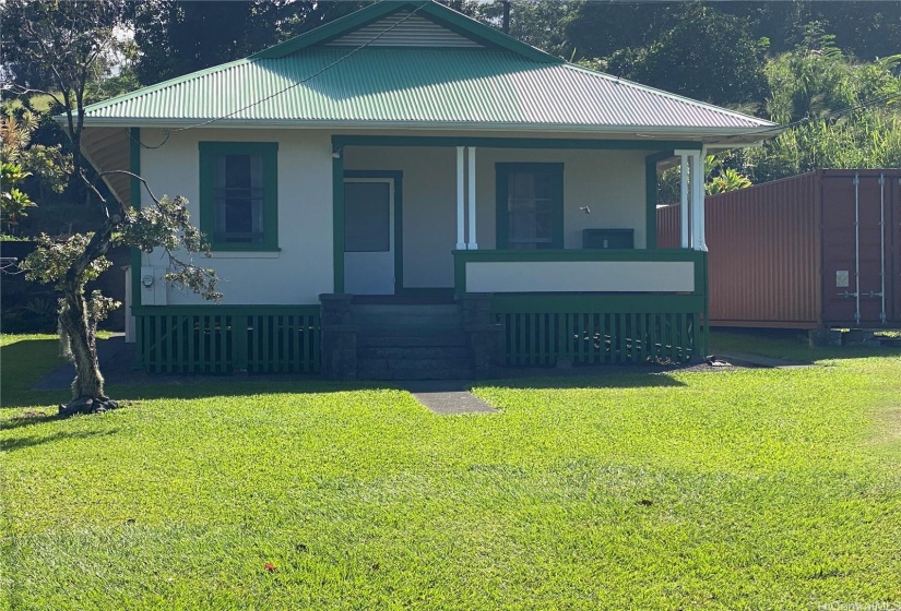 Gently sloping lot with terraced land behind.