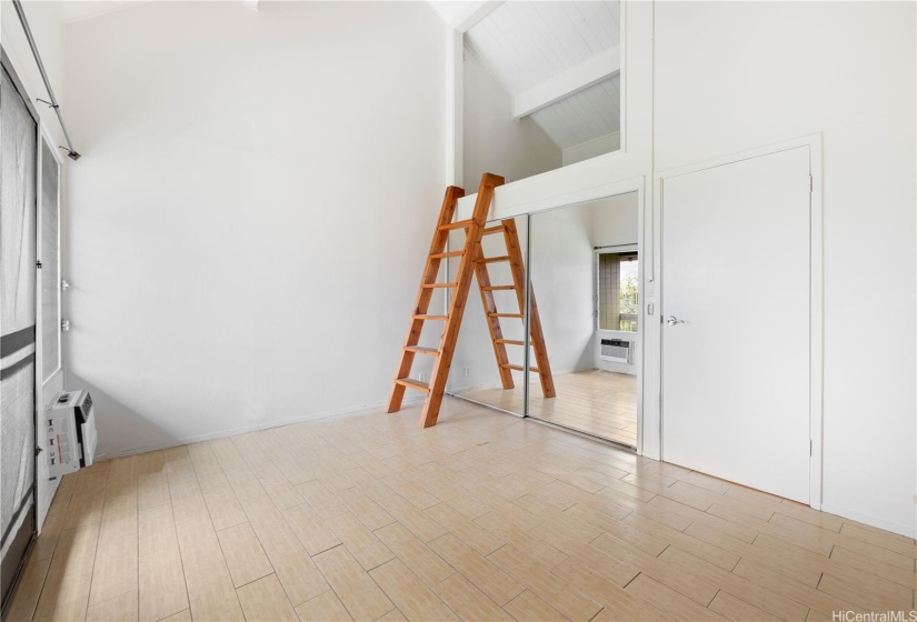 The primary bedroom has a unique drop-down ladder to an open loft area.