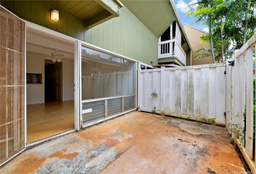 A front fenced porch patio upon entrance.