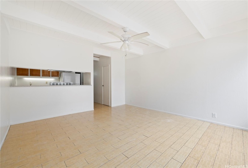 Different viewpoint of living room area leading into the kitchen.