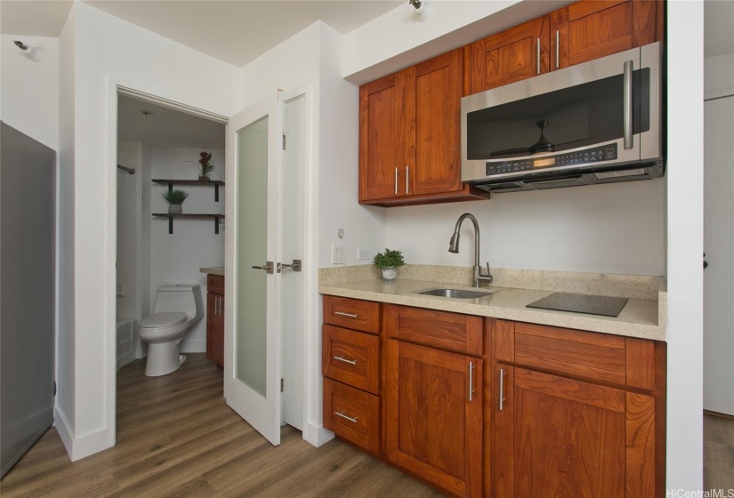 BATHROOM ENTRY NEXT TO KITCHEN.