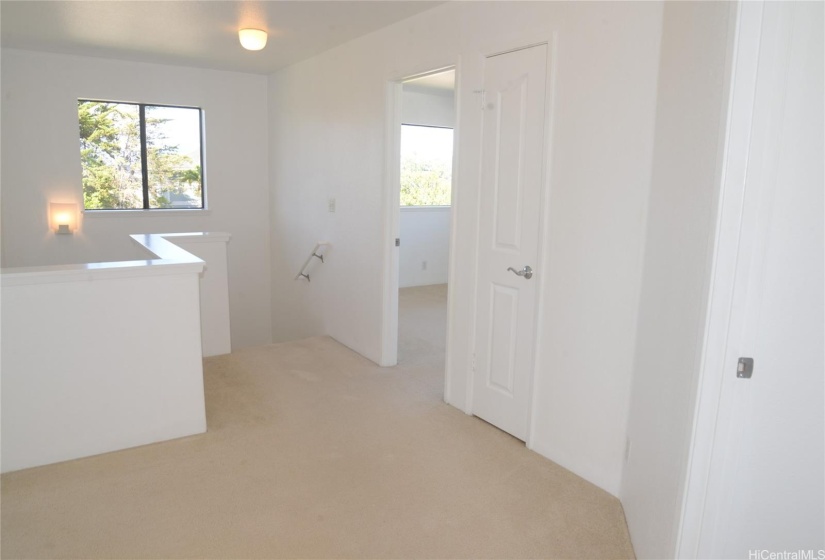 Second floor landing as shown from Bedroom number 3.    Bedroom number 4 just above the stairs and Main Bedroom entry in right corner.  Bedroom number four would be on left side of photo.