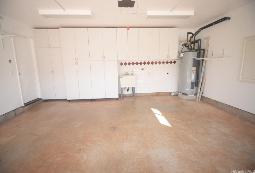 Garage with cabinet upgrade and solar water heater.  Laundry area to for full size laundry appliances