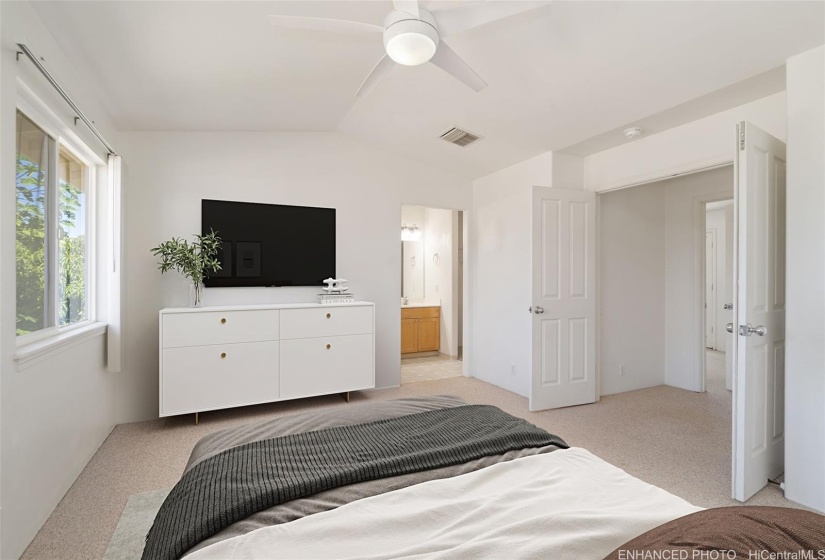 Primary suite features double doors to the hall. Enhanced with virtual staging.