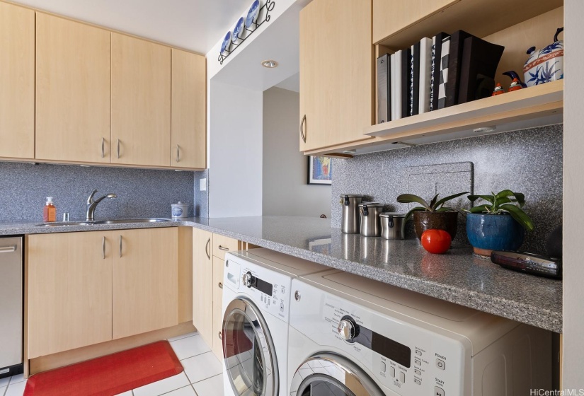 High efficiency washer and dryer are full sized and fit under the counter.