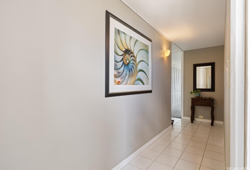 This is what you see from the front doorway; long artwork entry hallway gives you privacy when entering this end unit.