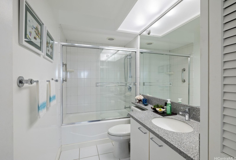 Guest bathroom is easily accessed from living area and not located inside a bedroom.  This bathroom looks like a brand new model home's display.  Also has a power flush toilet recently installed.