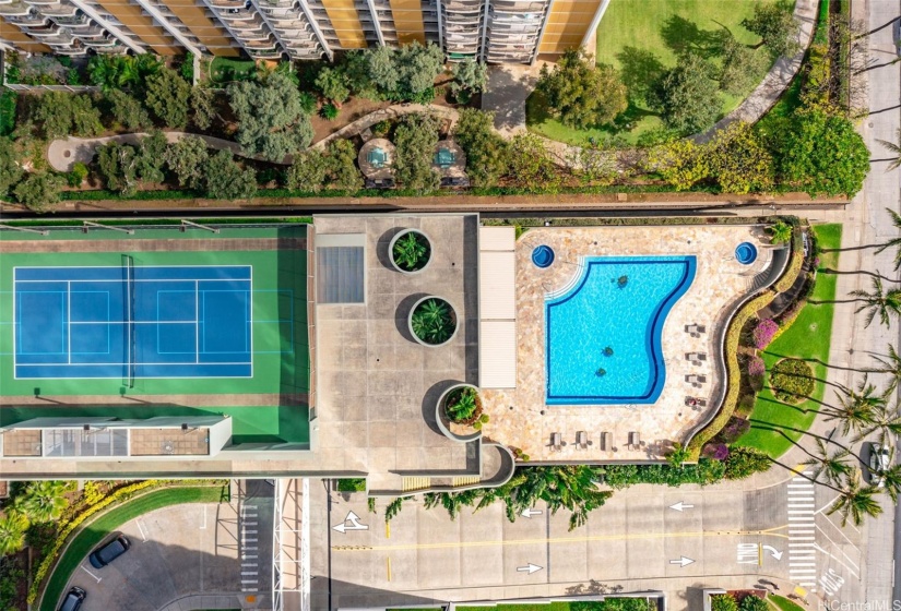 view of the tennis courts and the pool from the living area