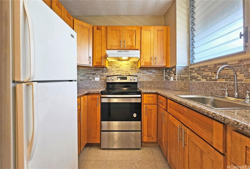 Renovated kitchen w/ stainless steel range and microwave