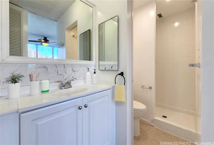 Virtually staged(enhanced). Primary full bathroom w/ freshly glazed shower and new paint.