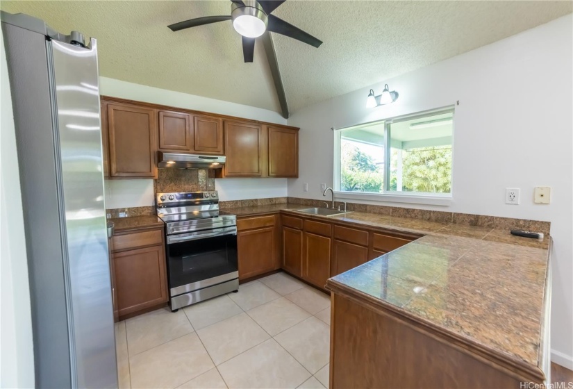 Open kitchen, with a new stove.