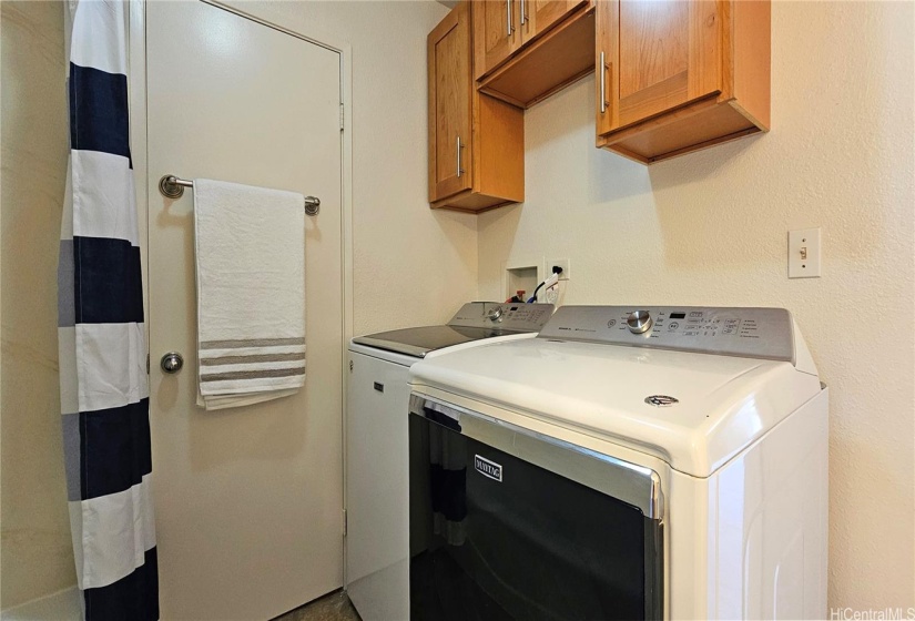 Full-sized Washer and Dryer located in bathroom