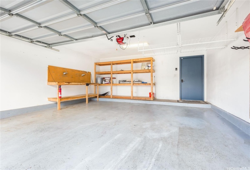 2 car detached garage with workbench and shelving.