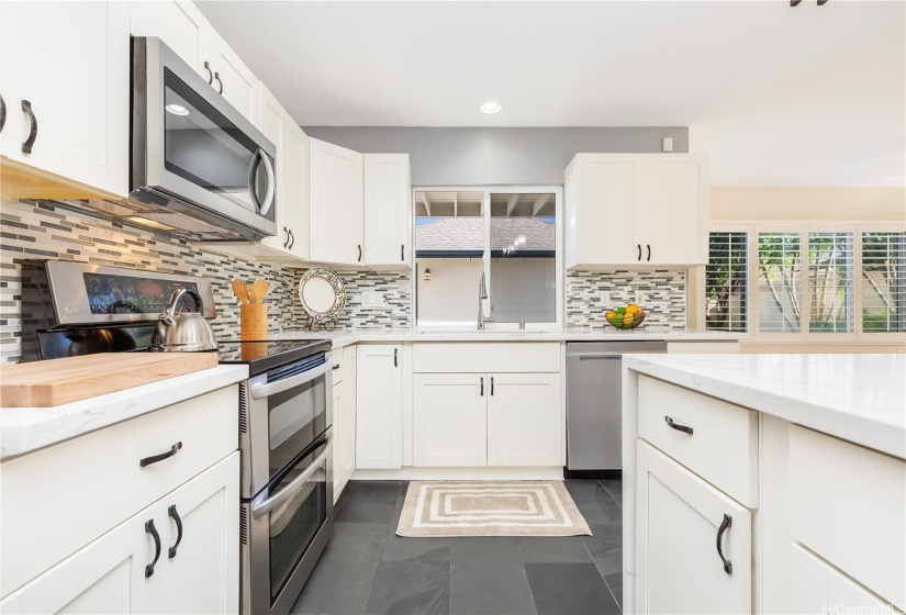 Re-freshed kitchen has an island overlooking the living area.