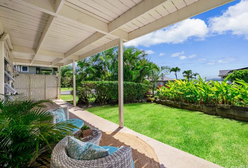 Large 320sf covered lanai on the ground level and side yard. The downstairs unit can be accessed from this area and is all ground level with no stairs for easy access. There are ocean views from this lanai!