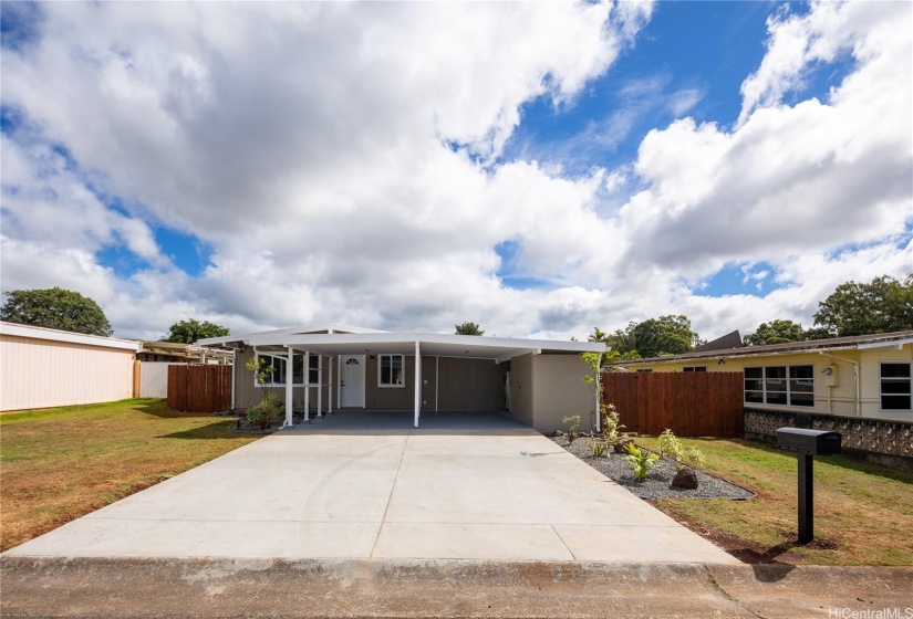 Two-car carport and large driveway with room for at least two additional cars.