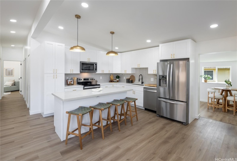 Open concept with kitchen island and entry into the flex space off the kitchen.