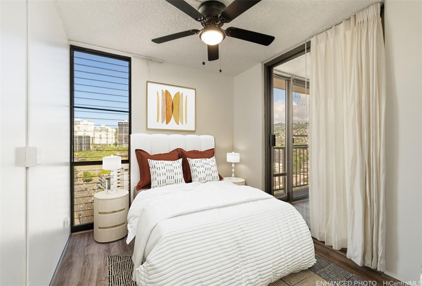 Second bedroom with sliding door to living area. Enhanced with virtual staging.