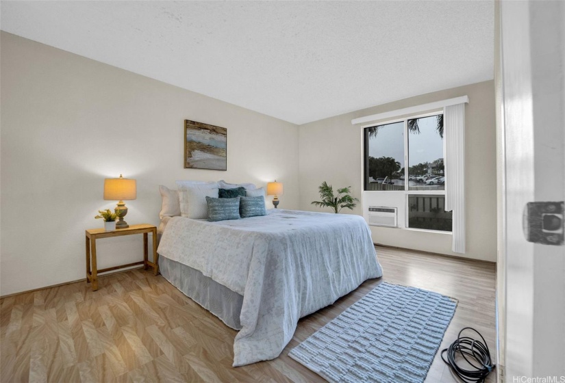 Spacious primary bedroom with double doors