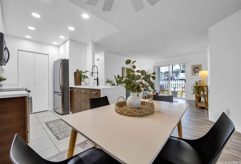 Dining area, kitchen and living room flow together with sliding doors to the lanai.