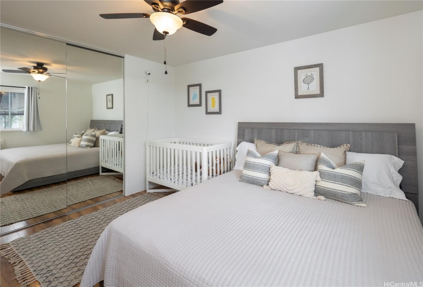 Another view of the bedroom; a large walk in closet is behind the mirrored doors.