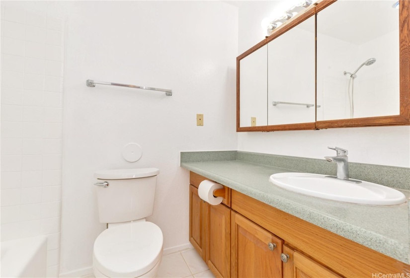 The bathroom vanity is just across from the bathtub.