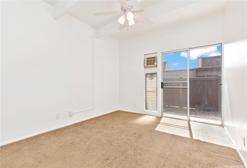 A sliding glass door gives a private sitting area on the adjacent lanai.