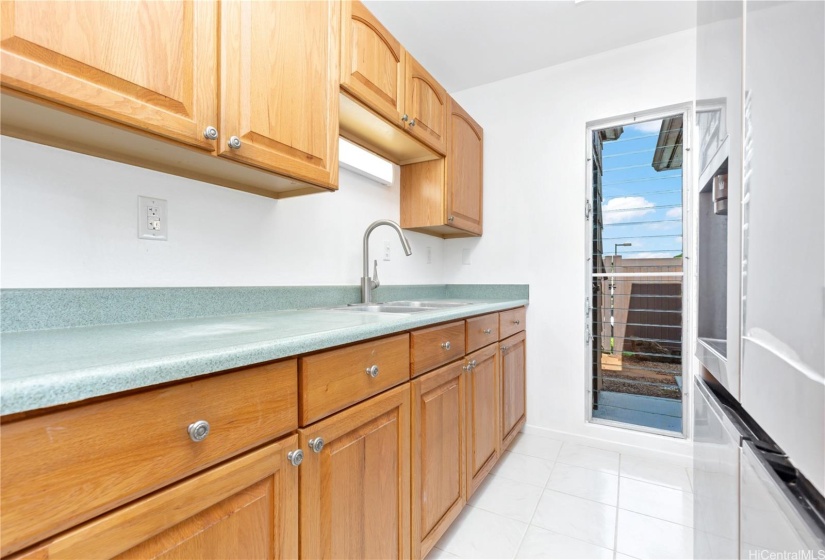 A kitchen window let’s in lots of natural air.  Look at all of the counter space.