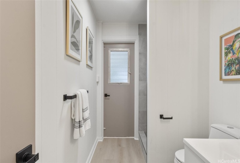 Renovated full bathroom with door that leads to the lanai.