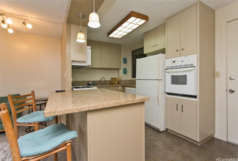 Open kitchen area with microwave, dishwasher, stove and refrigerator