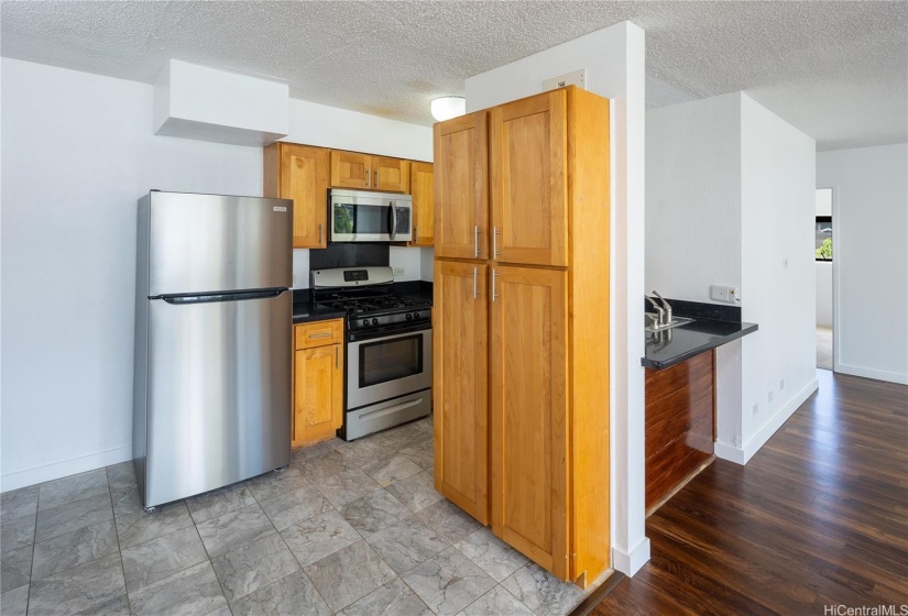 Kitchen has brand new refrigerator and microwave hood