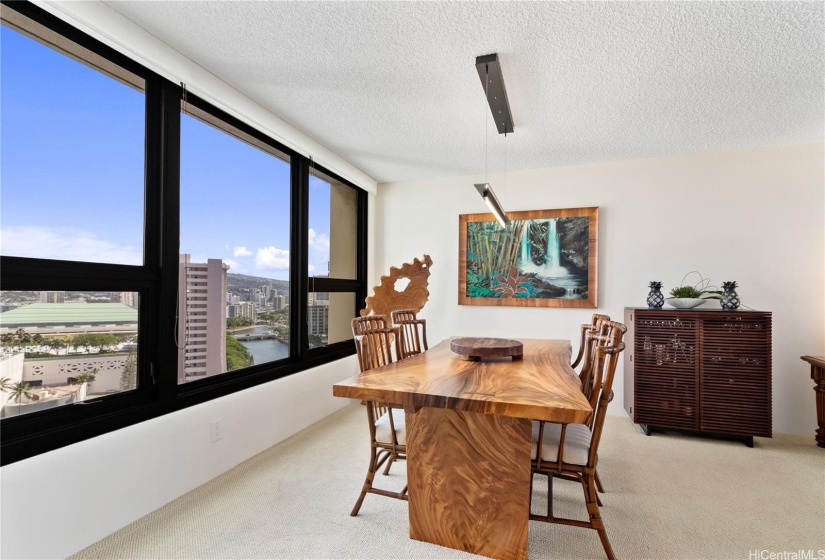 DINING AREA WITH CUSTOM LIGHTING AND CANAL AND MOUNTAIN VIEWS.