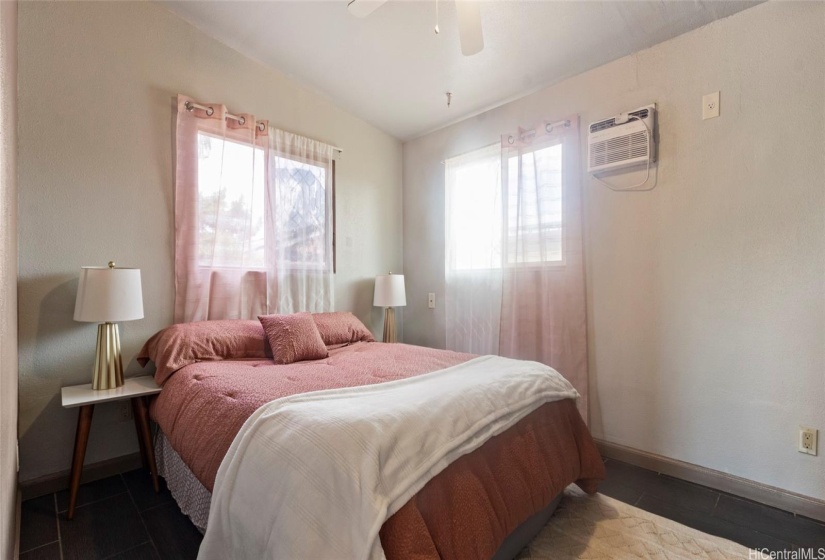 Bedroom #3 with newer vinyl sliding windows and air conditioning unit.