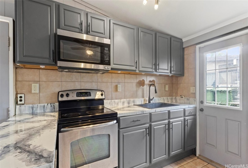 Large open kitchen layout with lots of cabinet space.