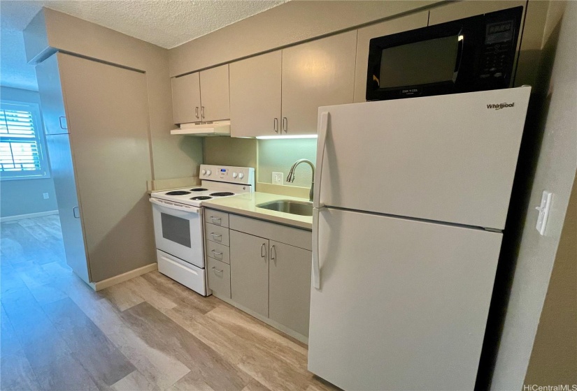 The kitchen offers a full-size range/oven with hood and refrigerator to prepare meals.  Cabinets above and below as well as a pantry closet.