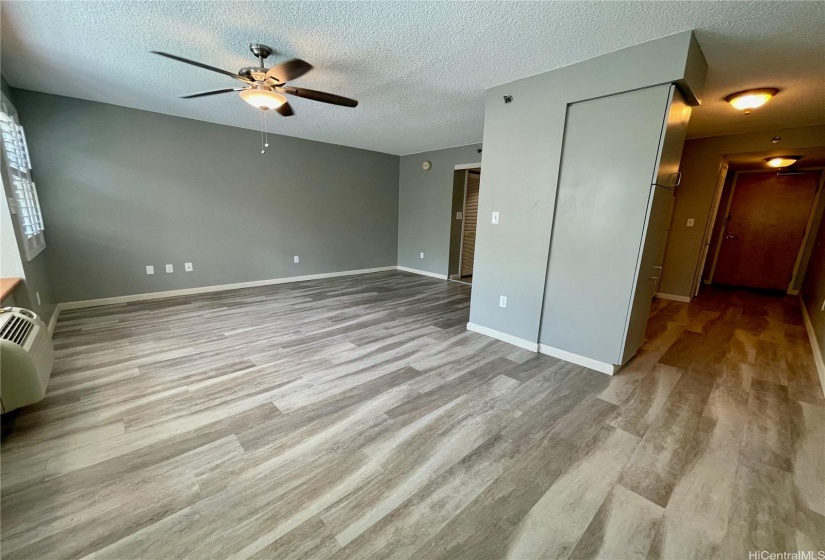 A view of the kitchen area to the right and the living room.