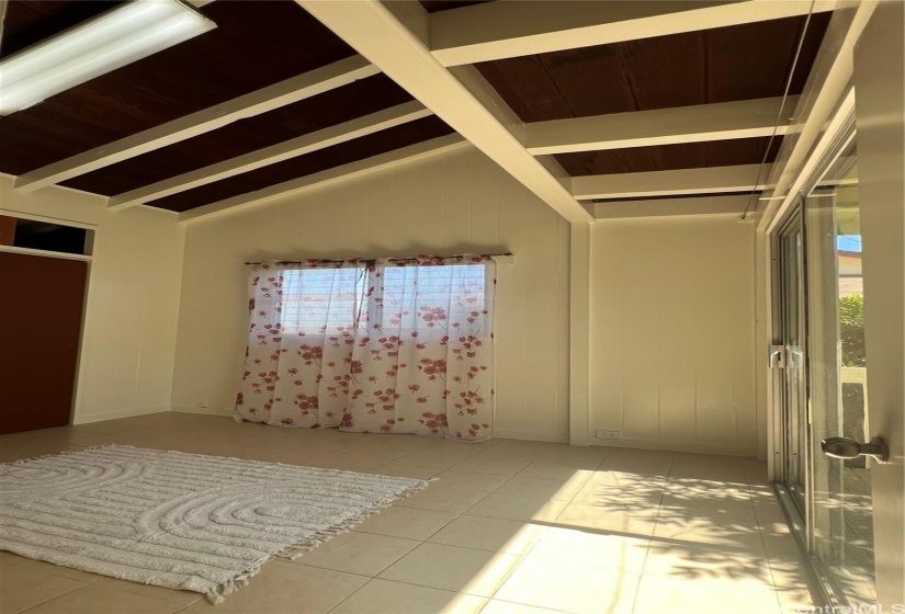 Upstairs bedroom 1 with high ceiling and balcony access