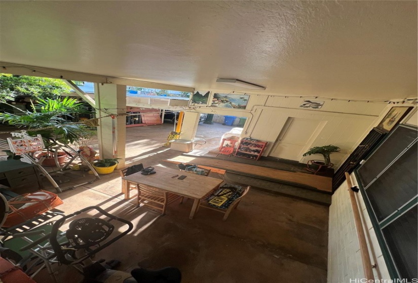 Covered patio. View from stairs to upper floor. Fruit tree canopy provides privacy and coverage.