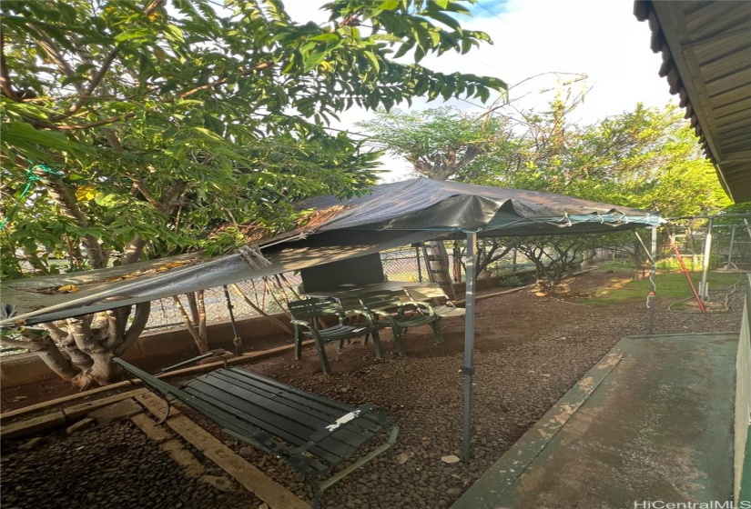 Front yard with sitting area and sink on the side.