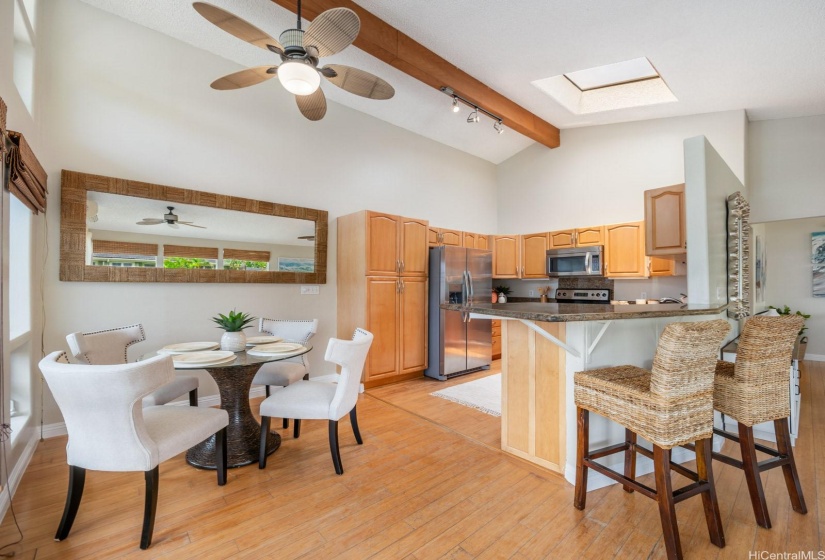 Dining and kitchen area with bar seating.