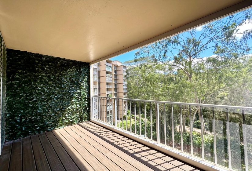 Upgraded lanai with plank flooring and greenery wall